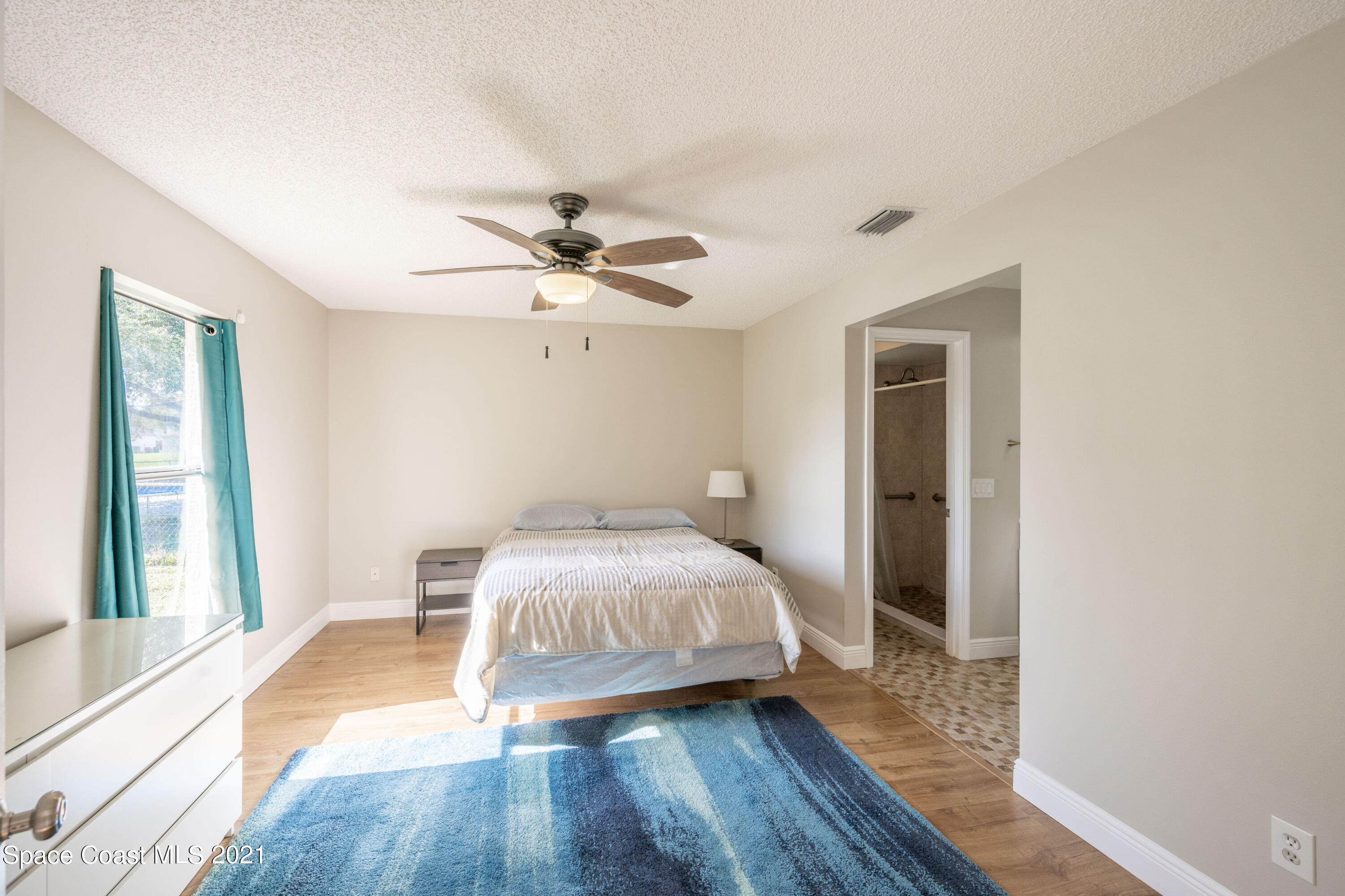 265 Oak Lake Road Melbourne, FL 32901 - Photo 8 of 25 a bedroom with a bed and a large window