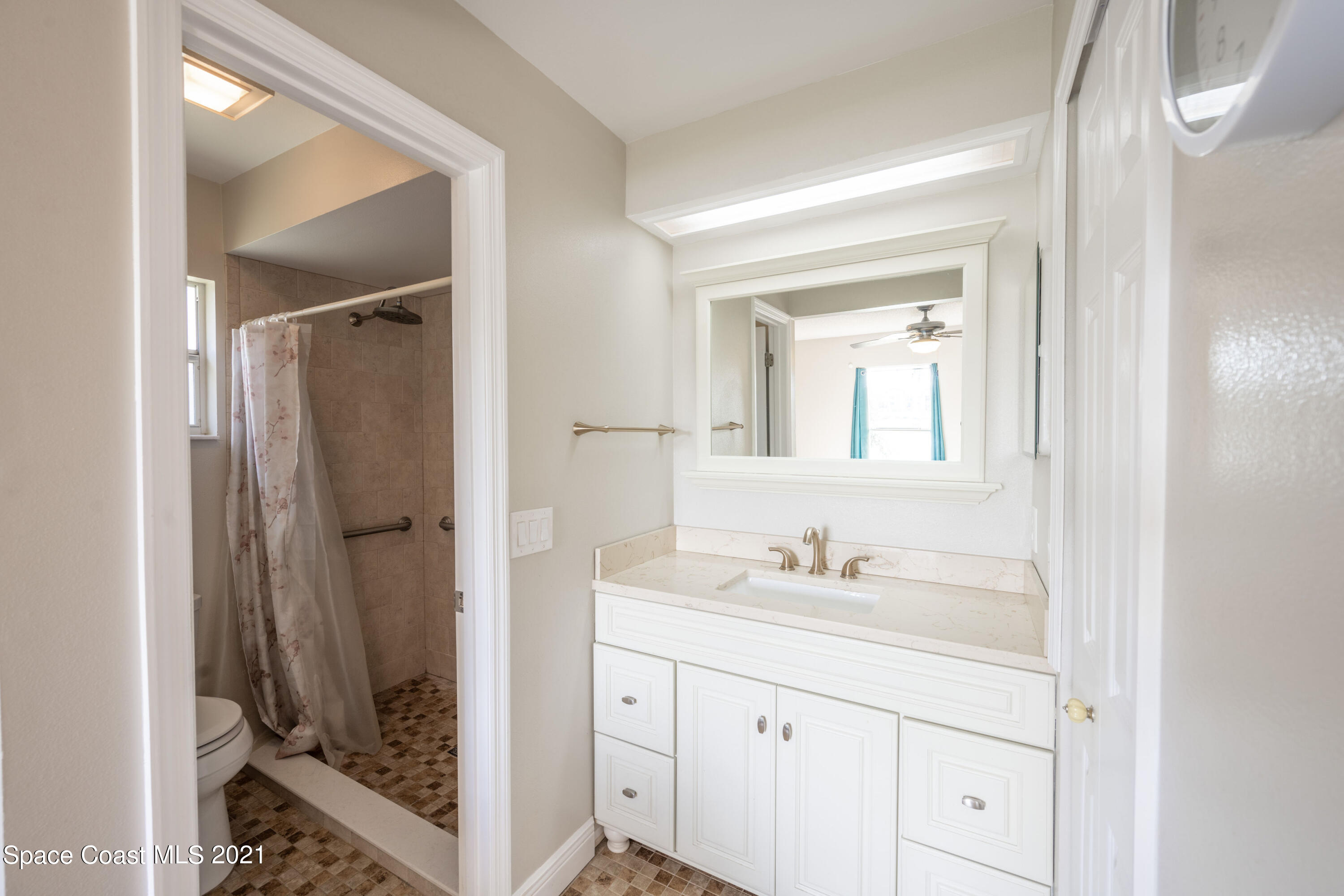 265 Oak Lake Road Melbourne, FL 32901 - Photo 9 of 25 a bathroom with a granite countertop sink shower and a mirror