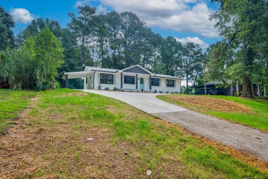 3251 Hopkins Road Powder Springs, GA 30127 - Photo 1 of 1 a view of a house with a yard and sitting area
