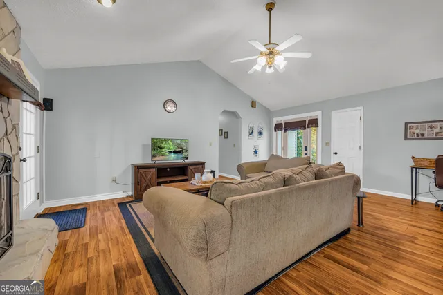 a living room with furniture a fireplace and a flat screen tv