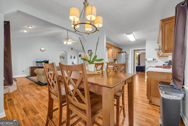 a large kitchen with stainless steel appliances granite countertop a stove a sink and a refrigerator