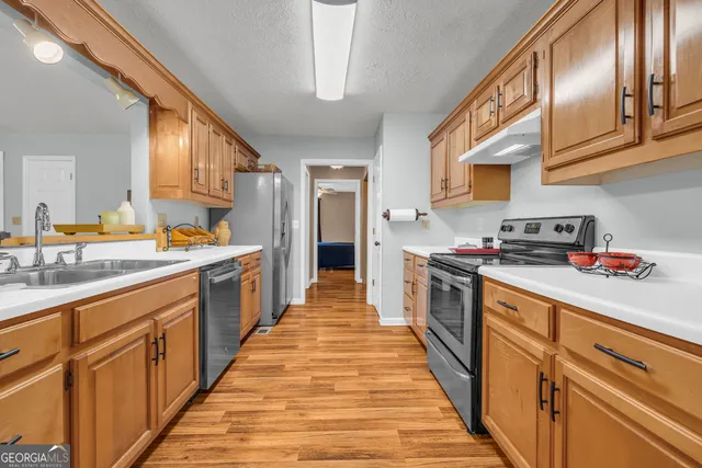 a view of hallway with wooden floor