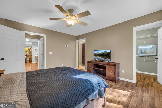 a bathroom with a granite countertop sink a mirror and a shower