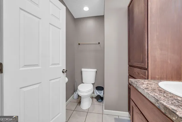 a bedroom with a bed and a chandelier fan