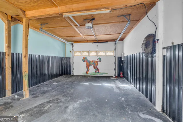 a front view of house with yard and trees all around