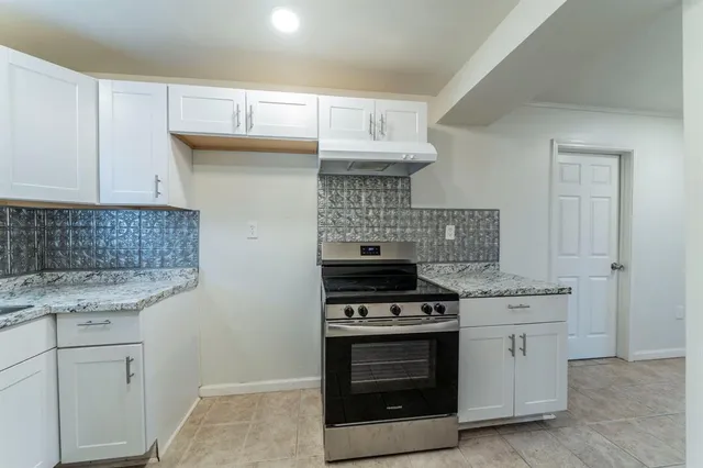 a kitchen with stainless steel appliances granite countertop a stove and a sink