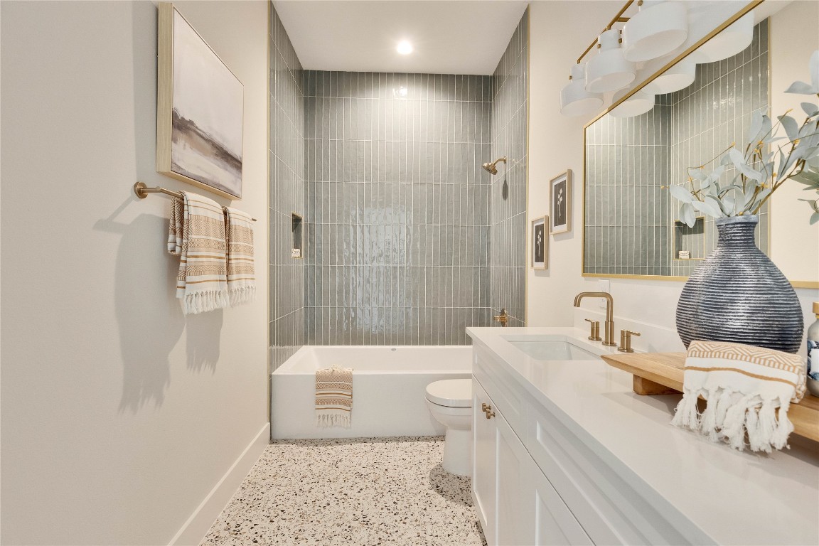 1937 East 38th 1/2 Street, Unit B Austin, TX 78723 - Photo 18 of 23 a bathroom with a sink a toilet and shower