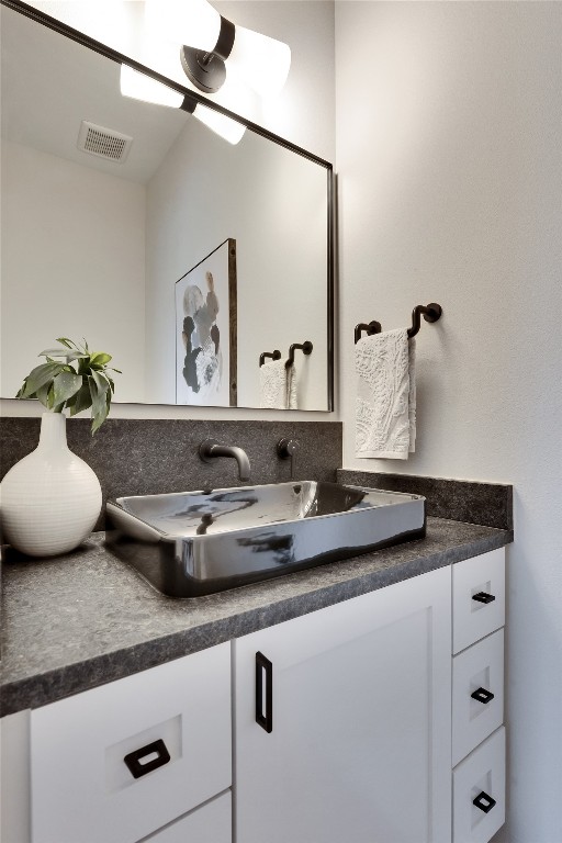 1937 East 38th 1/2 Street, Unit B Austin, TX 78723 - Photo 10 of 23 a bathroom with a granite countertop sink and a mirror