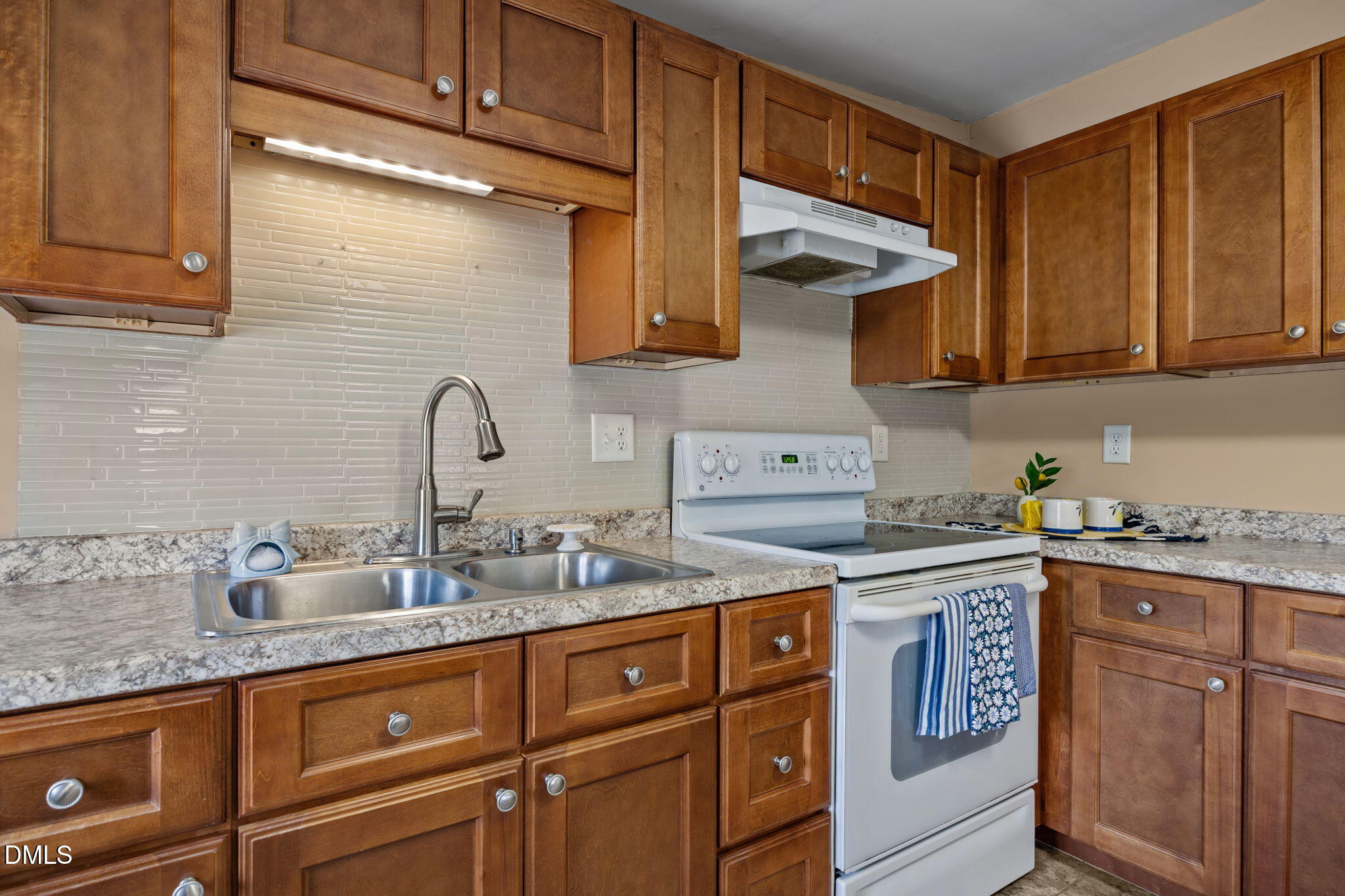 209 Weston Road Garner, NC 27529 - Photo 10 of 37 a kitchen with stainless steel appliances granite countertop a sink stove and cabinets