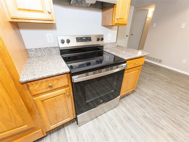 a kitchen with wooden floors and a stove