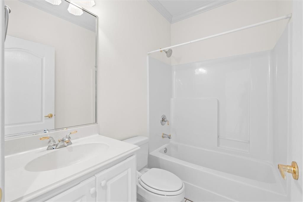 1030 Lakeview Parkway Villa Rica, GA 30180 - Photo 18 of 46 a bathroom with a granite countertop sink toilet and shower