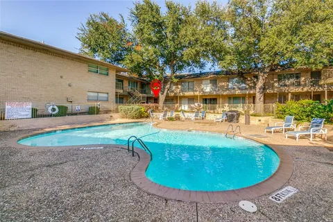 a view of a swimming pool with outdoor seating