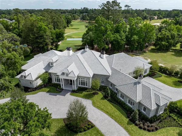 an aerial view of a house with a yard