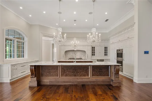 a view of kitchen with granite countertop cabinets and window
