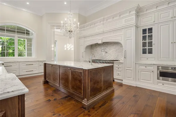 a stove top oven sitting inside of a kitchen