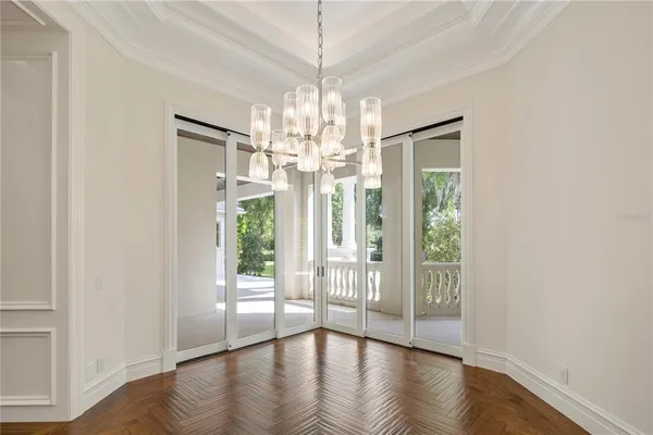 a view of a dining area with wooden floor and staircase