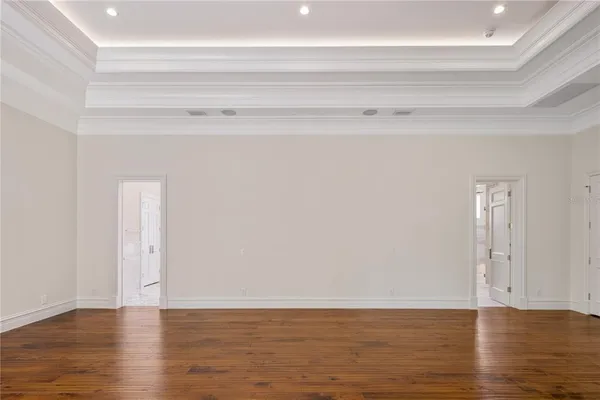 a view of wooden floor and windows in a room