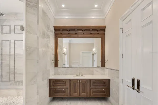 a spacious bathroom with a granite countertop sink a toilet a mirror and shower
