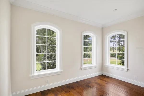 a view of an empty room with a fireplace and a window