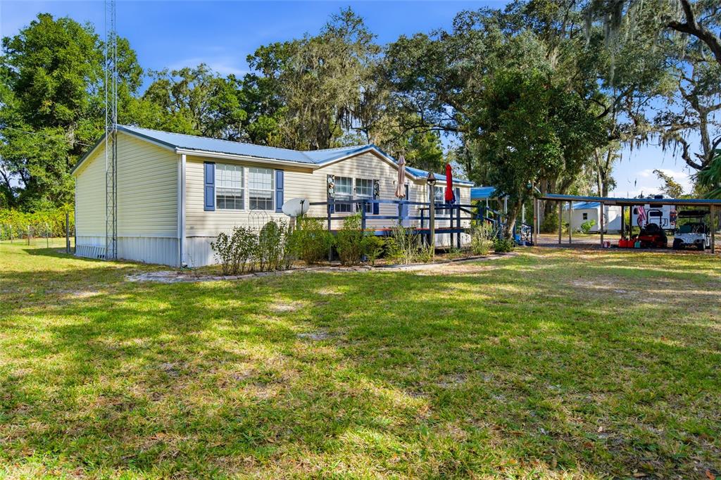 a front view of house with yard and trees in the background