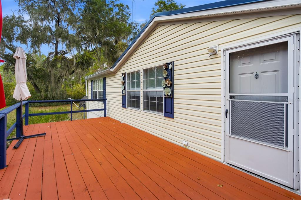 2804 Southwest 67th Lane Bushnell, FL 33513 - Photo 2 of 48 a view of backyard with a deck and wooden floor