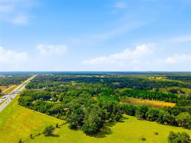 a yellow building with trees in the background
