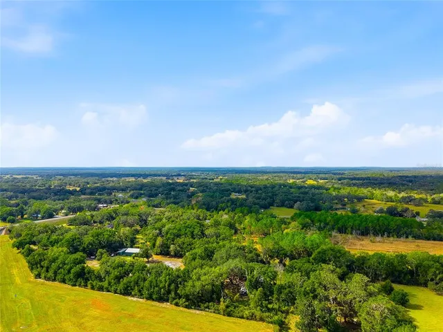 a kitchen with stainless steel appliances a refrigerator a sink a stove a refrigerator white cabinets and wooden floor