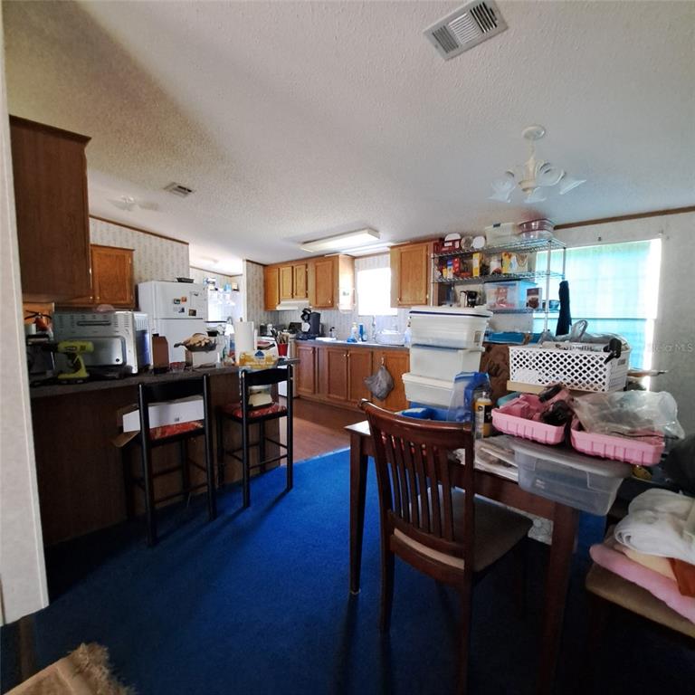 2804 Southwest 67th Lane Bushnell, FL 33513 - Photo 37 of 48 a living room with lots of furniture and kitchen view
