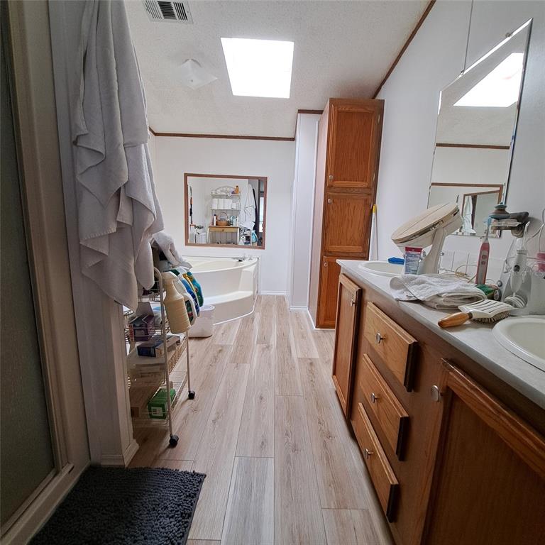 2804 Southwest 67th Lane Bushnell, FL 33513 - Photo 46 of 48 a storage room with wooden floor and furniture