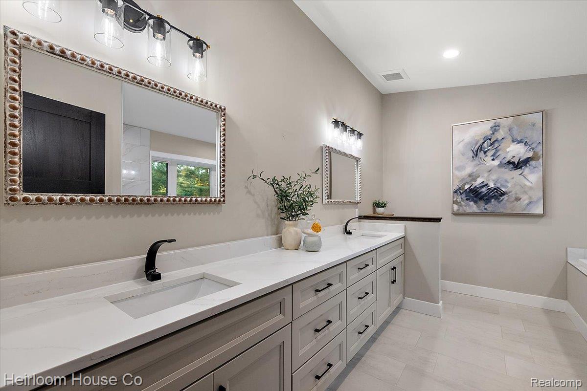49001 Hanford Road Canton, MI 48187 - Photo 13 of 98 Double vanity with light gray cabinetry, white countertops, and integrated rectangular sinks