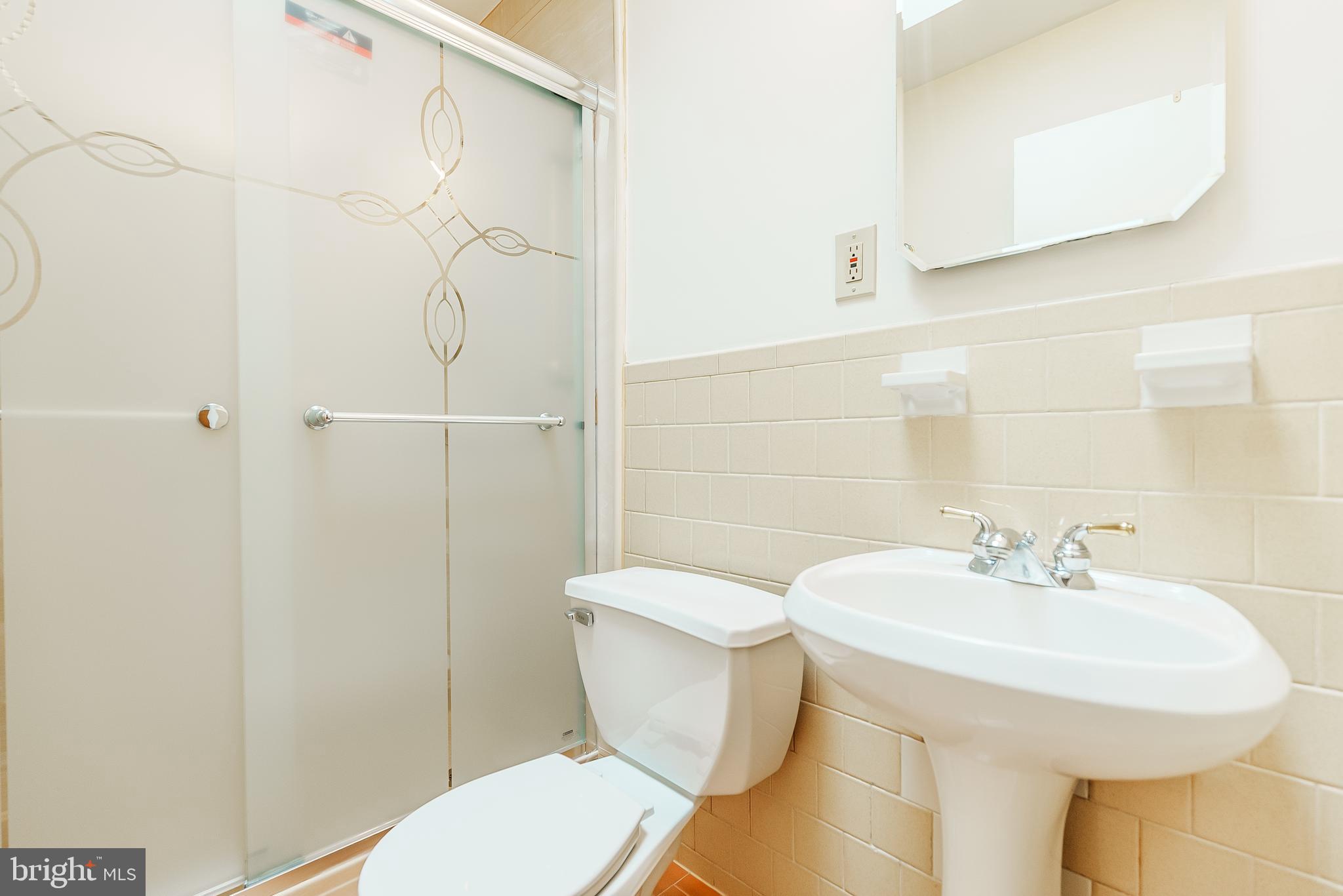 548 Paddock Road Ambler, PA 19002 - Photo 14 of 15 a bathroom with a sink a toilet and shower