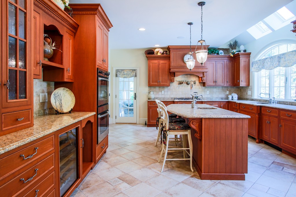 36 Dana Road Boxford, MA 01921 - Photo 6 of 28 a kitchen with a wooden table and chairs