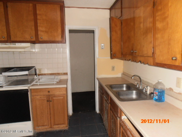 1748 Mayfair Road Jacksonville, FL 32207 - Photo 5 of 8 a kitchen with a sink stove and cabinets