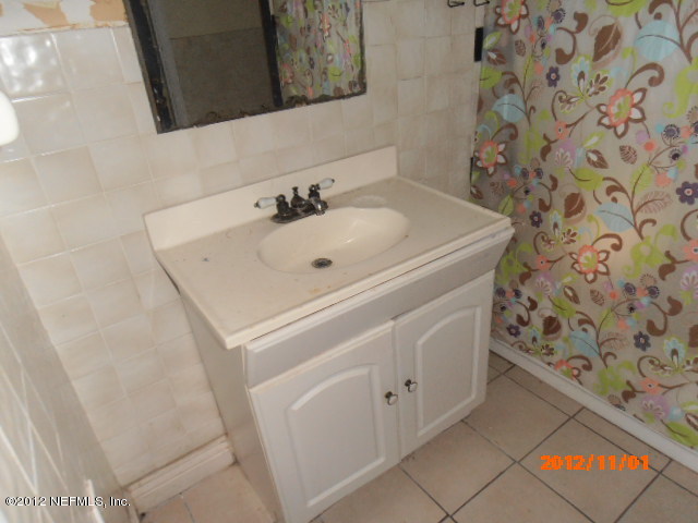 1748 Mayfair Road Jacksonville, FL 32207 - Photo 6 of 8 a bathroom with a sink and a mirror
