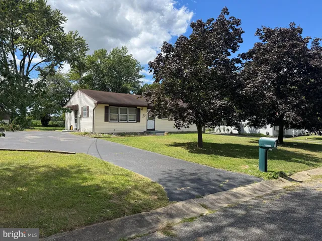 a view of a house with swimming pool and a yard