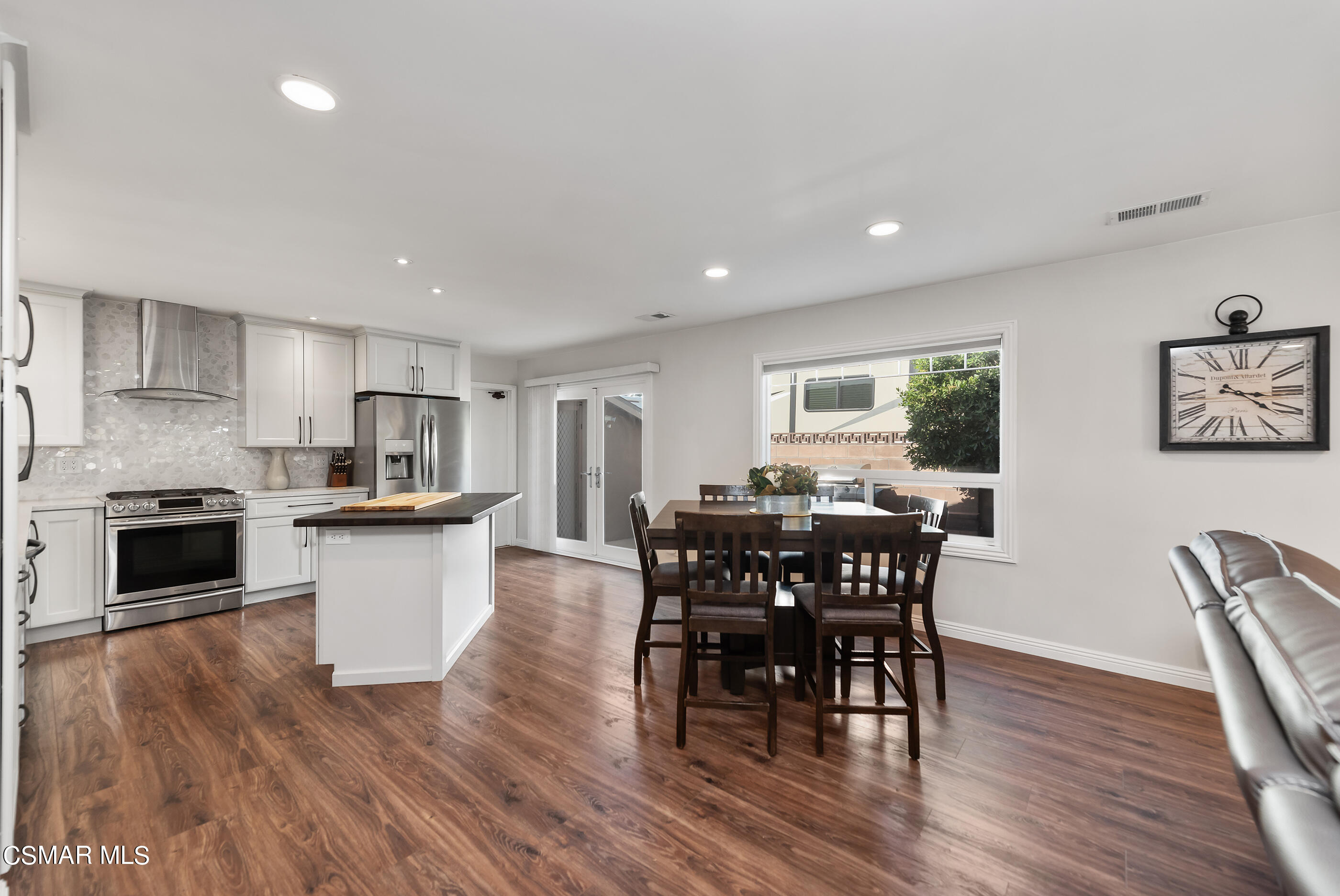 2066 Hurles Avenue Simi Valley, CA 93063 - Photo 18 of 50 a open dining room with stainless steel appliances wooden floor a dining table and chairs