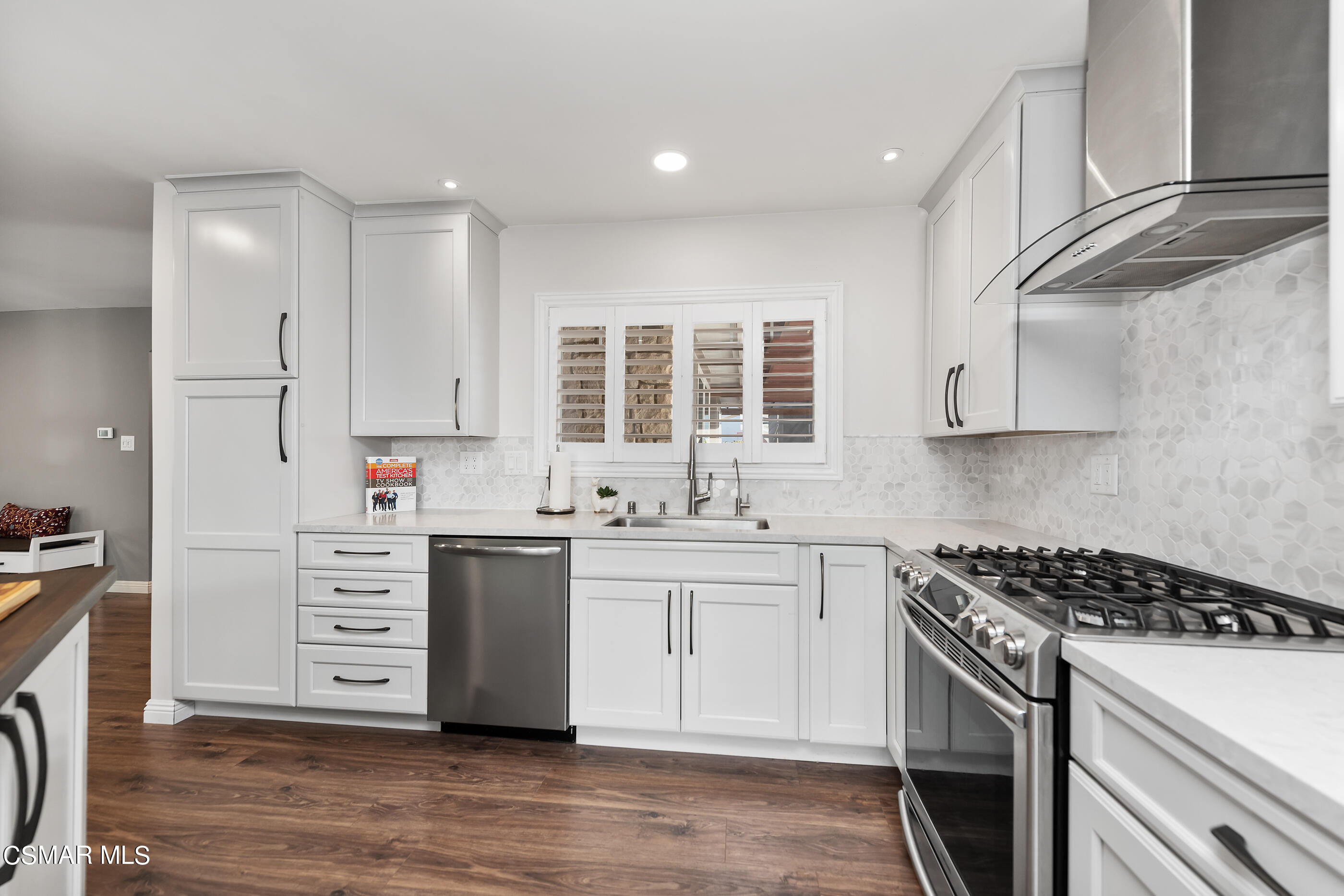 2066 Hurles Avenue Simi Valley, CA 93063 - Photo 21 of 50 a kitchen with stainless steel appliances a stove top oven and cabinets