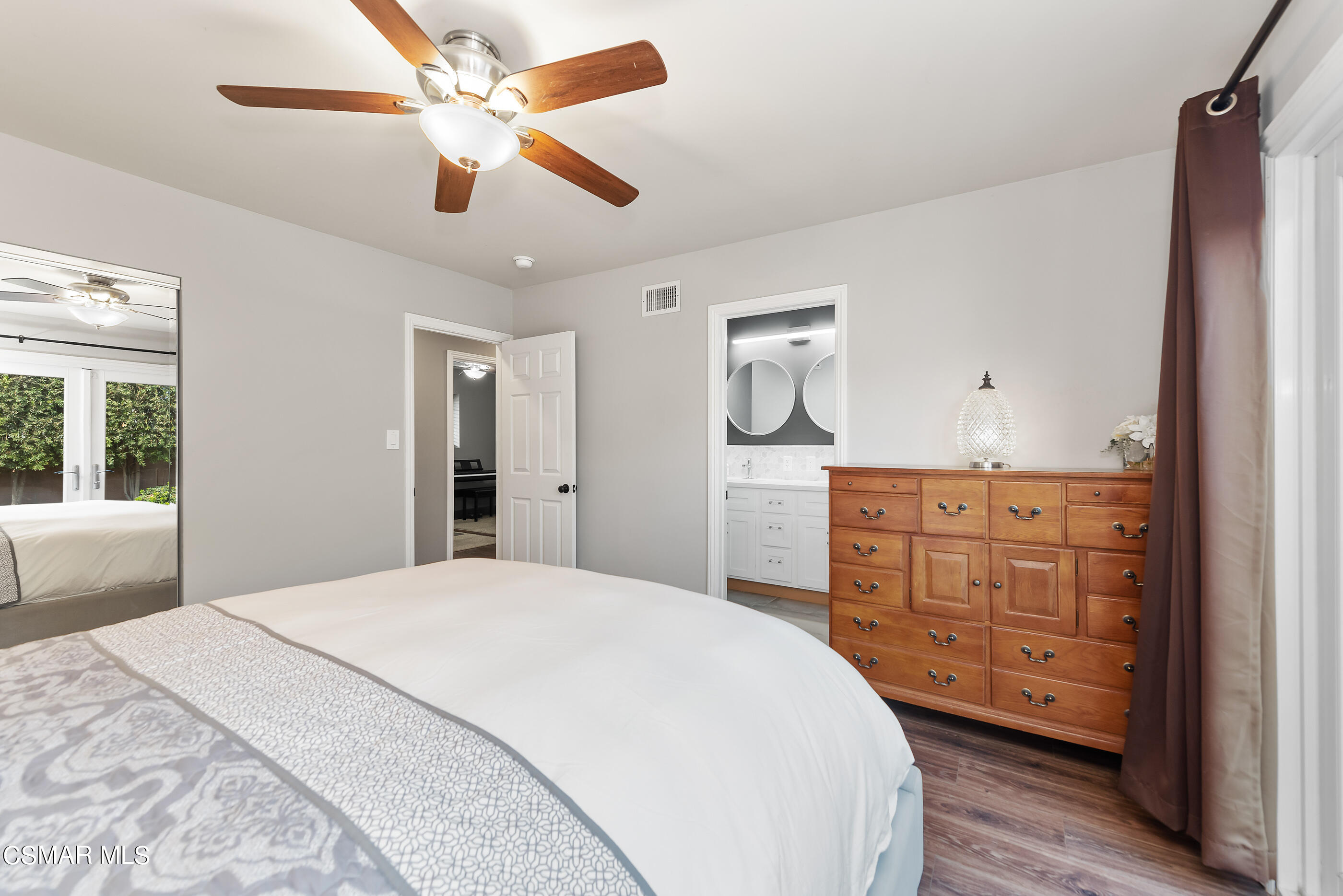 2066 Hurles Avenue Simi Valley, CA 93063 - Photo 29 of 50 a spacious bedroom with a bed a dresser and a chandelier