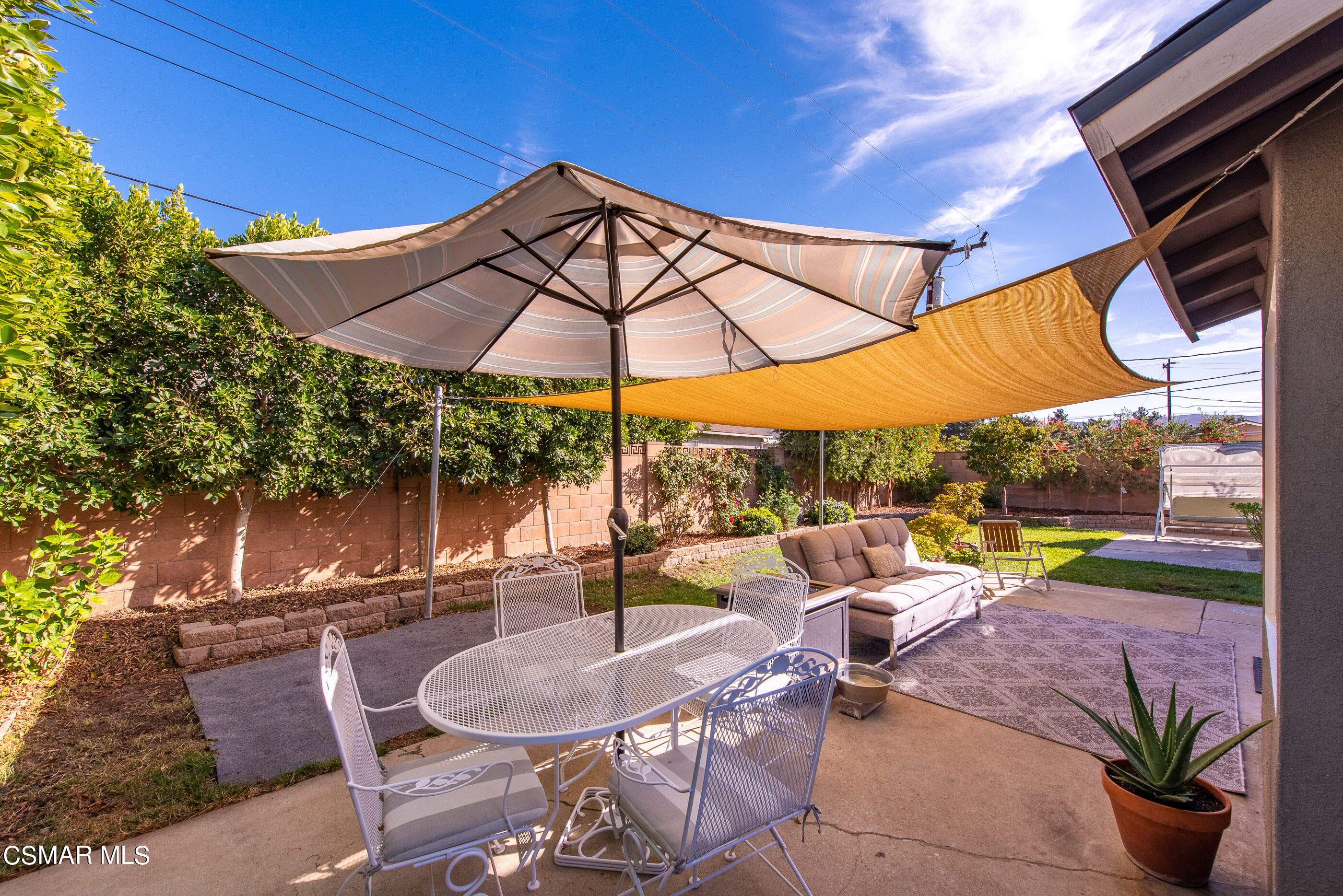 2066 Hurles Avenue Simi Valley, CA 93063 - Photo 31 of 50 a view of a patio with a table and chairs under an umbrella