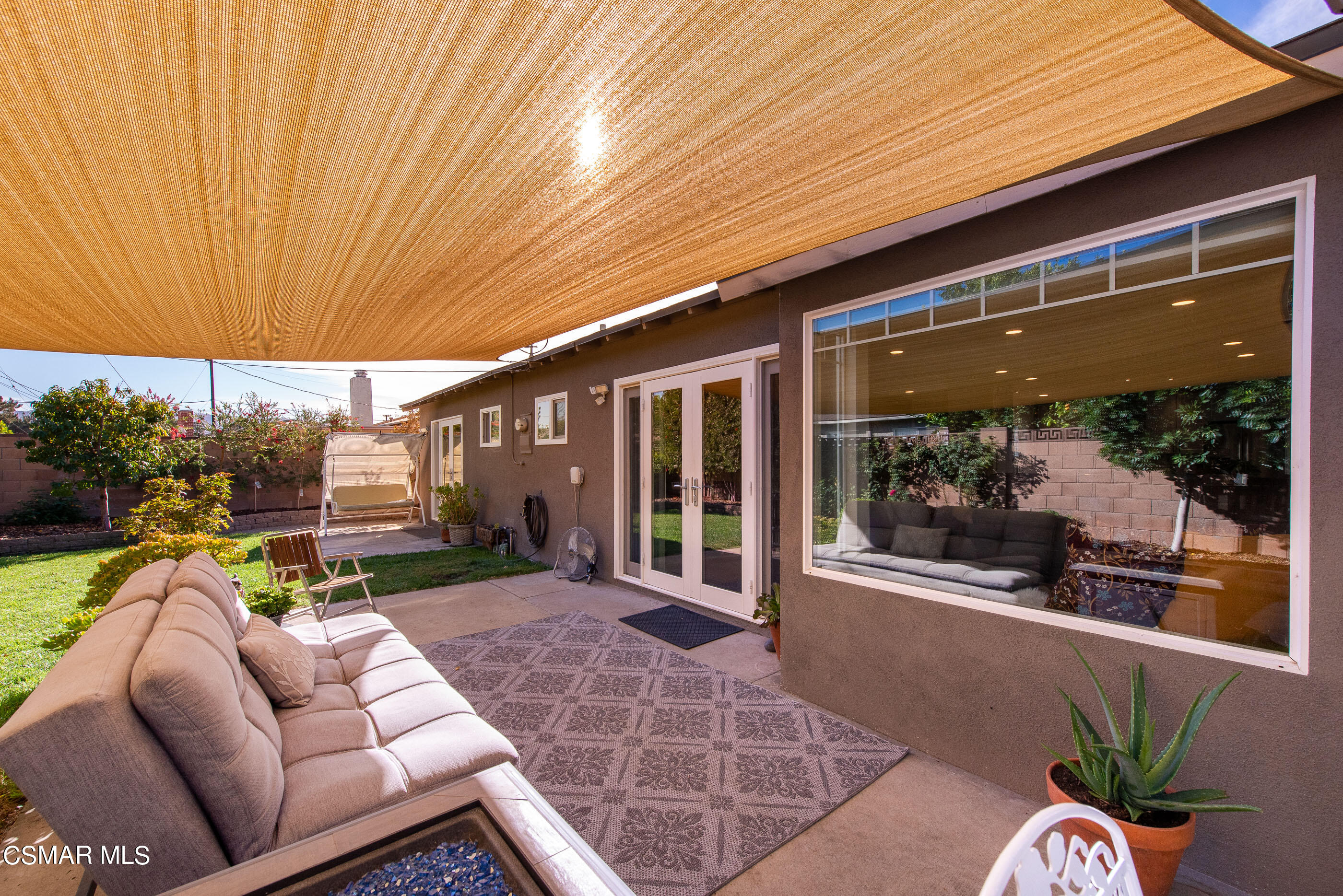 2066 Hurles Avenue Simi Valley, CA 93063 - Photo 33 of 50 a view of a patio with table and chairs potted plants and floor to ceiling window