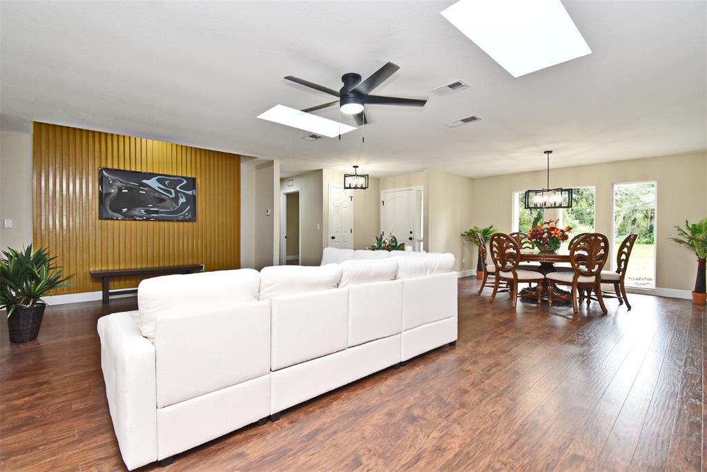 1444 Bird Road Casselberry, FL 32707 - Photo 11 of 70 a living room with furniture and wooden floor