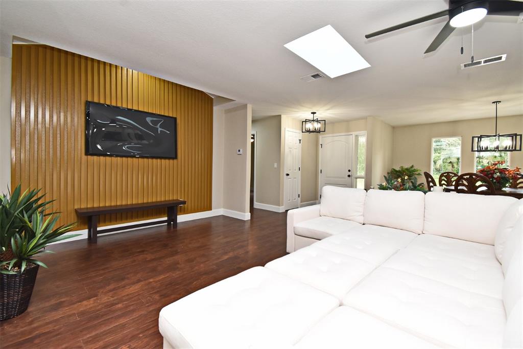 1444 Bird Road Casselberry, FL 32707 - Photo 12 of 70 a spacious bedroom with a bed and a dresser with wooden floor