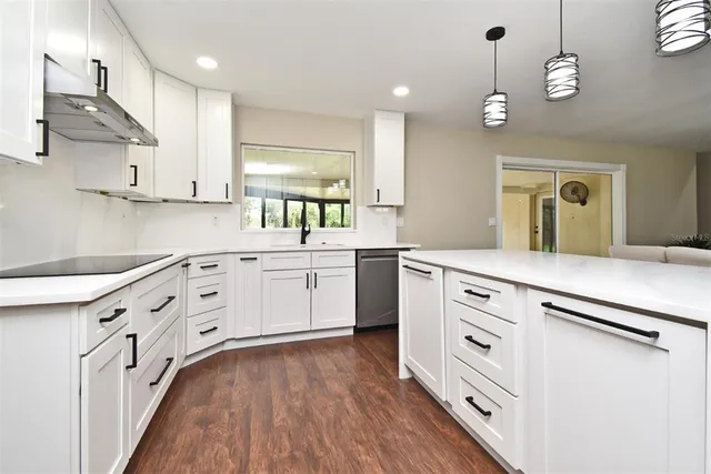 a kitchen with refrigerator a sink and a oven