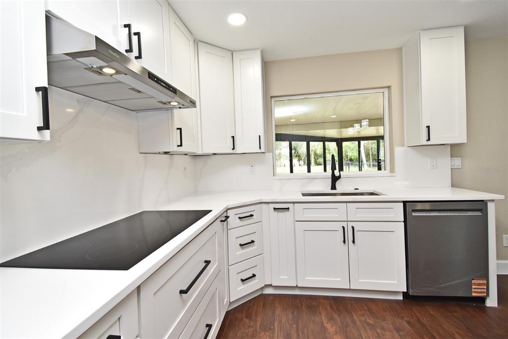 1444 Bird Road Casselberry, FL 32707 - Photo 16 of 70 a kitchen with white cabinets and sink