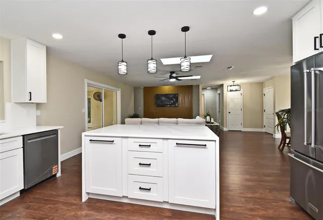 a living room with wooden floor and furniture