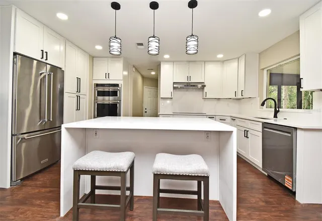 a view of empty room with wooden floor and ceiling fan