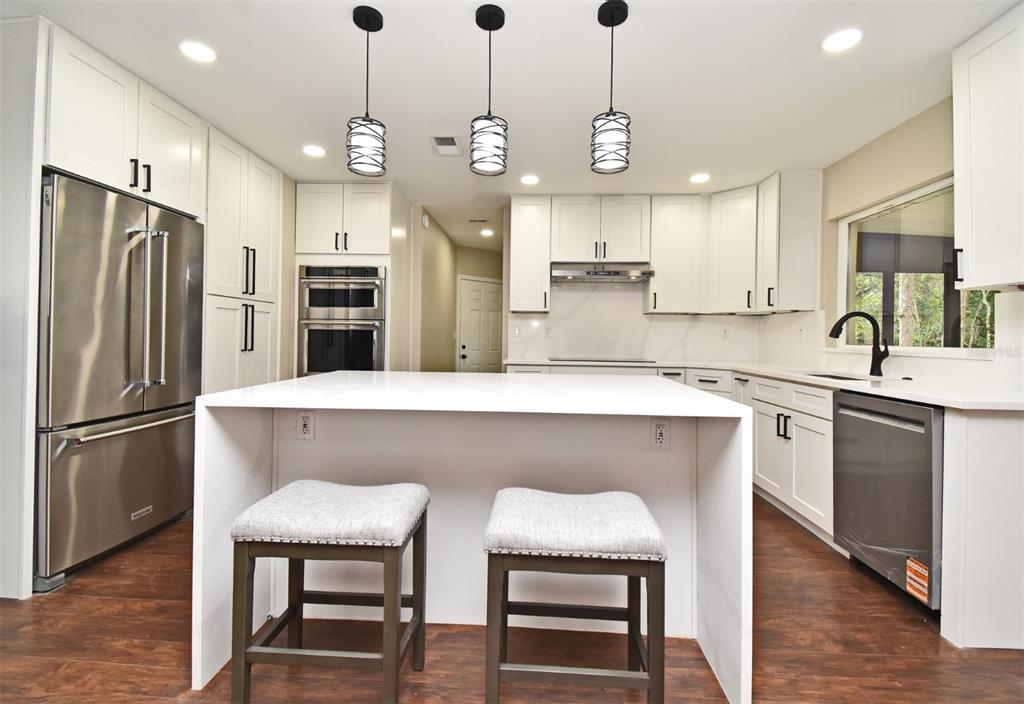 1444 Bird Road Casselberry, FL 32707 - Photo 19 of 70 a kitchen with refrigerator a sink and a oven