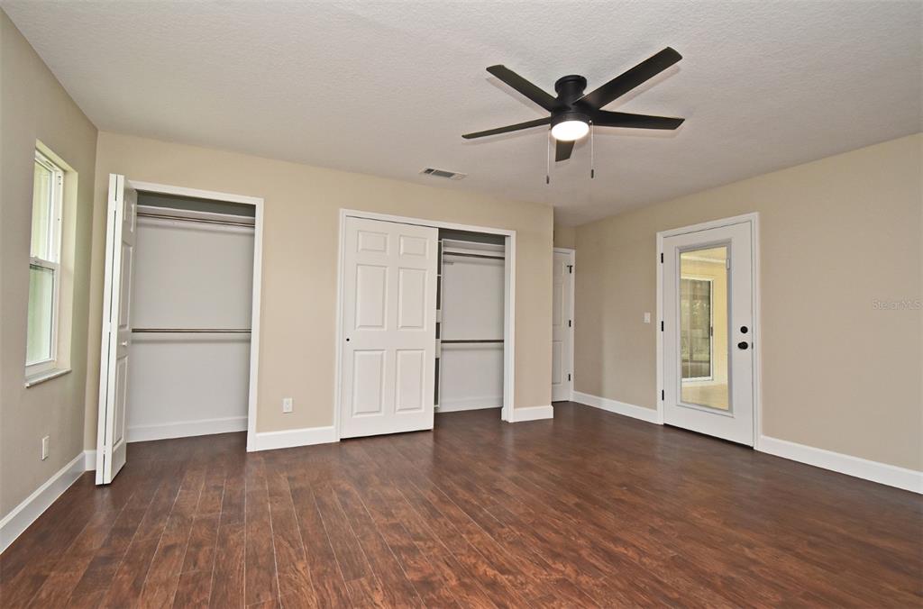 1444 Bird Road Casselberry, FL 32707 - Photo 20 of 70 a view of empty room with wooden floor and ceiling fan