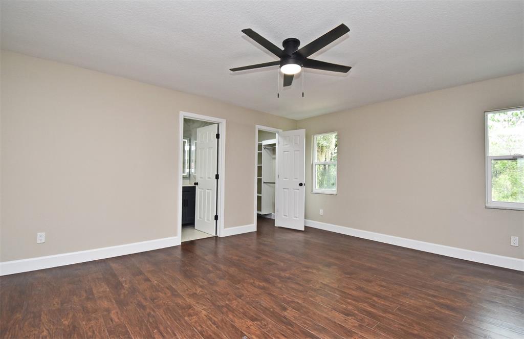 1444 Bird Road Casselberry, FL 32707 - Photo 25 of 70 an empty room with wooden floor and windows