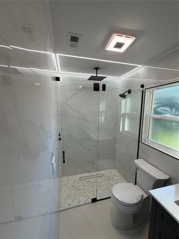 a view of empty room with window and wooden floor